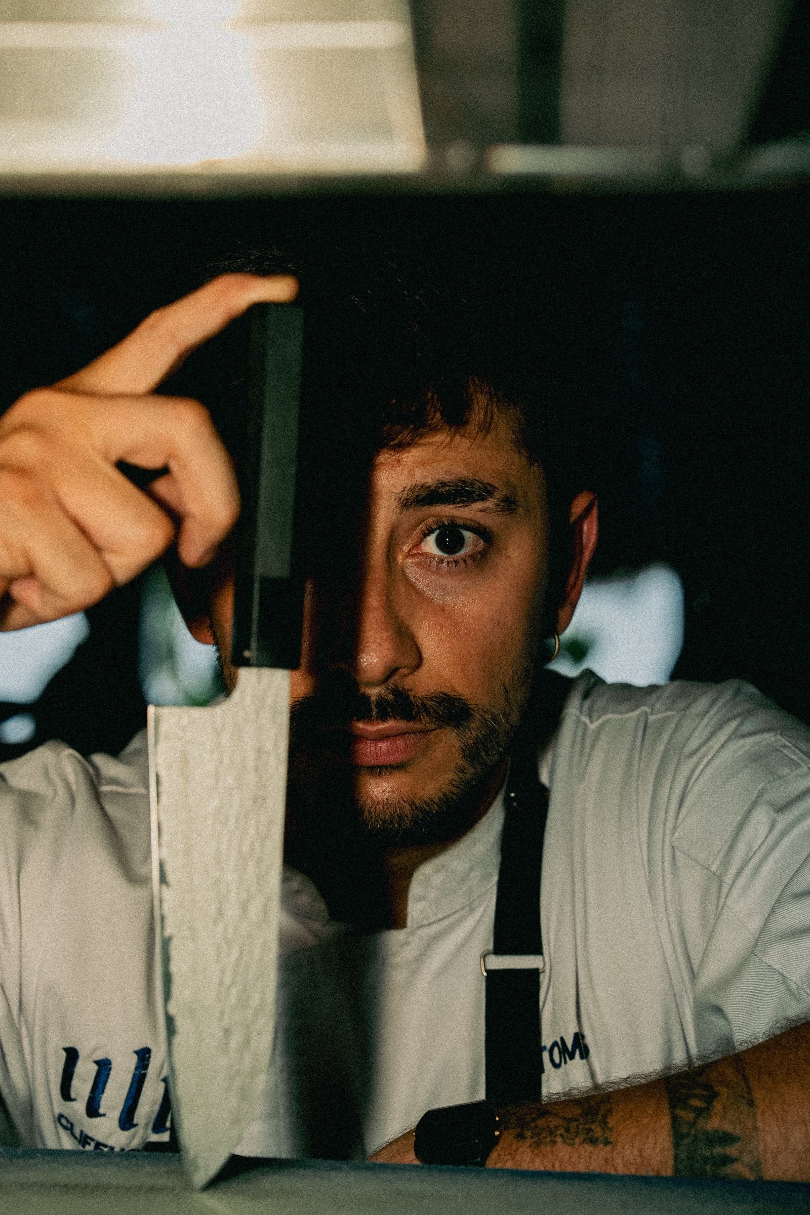 Chef Tomás serving a dish from the open kitchen at burnt.